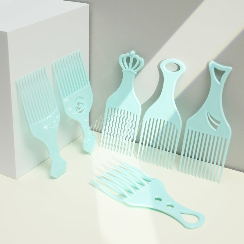 Set of light blue hair combs on a neutral background