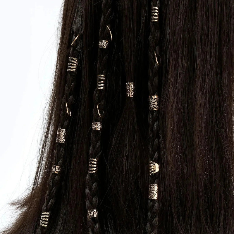 Close-up of braided hair extensions with decorative beads on a white background