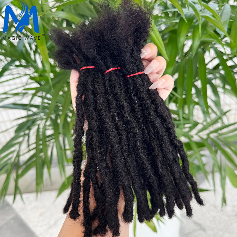 Black braided hair extensions held by a hand with a blurred green plant background