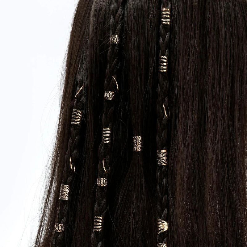 Close-up of braided hair extensions with decorative beads on a white background