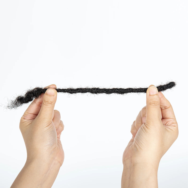 Two hands holding a small piece of black hair against a white background