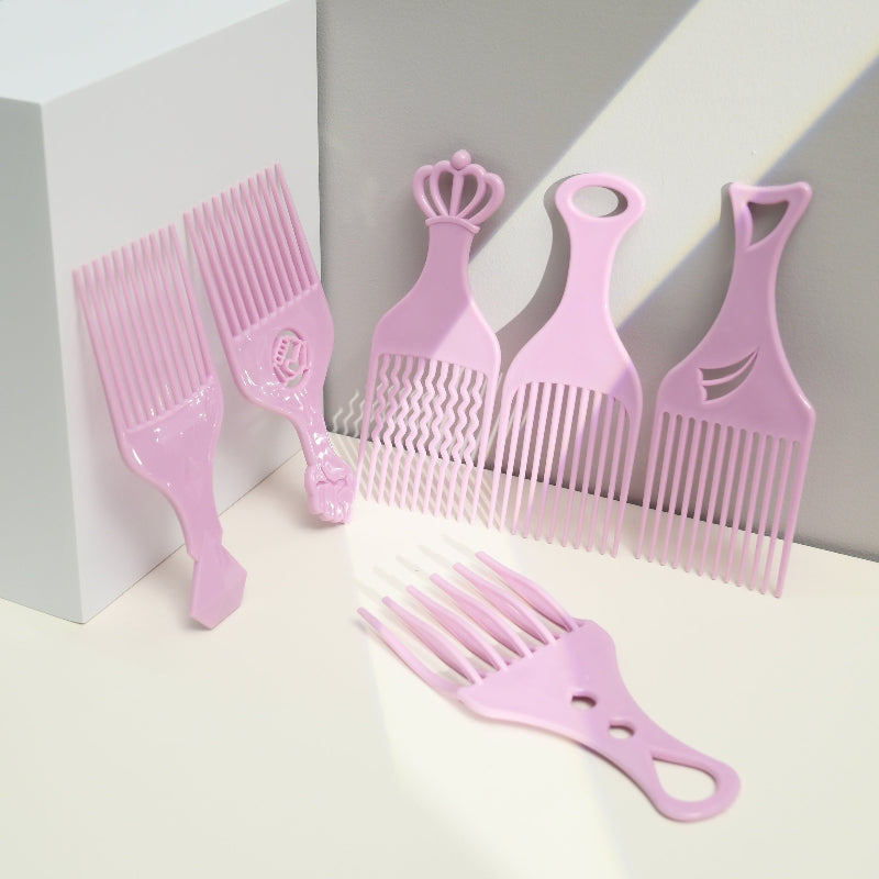 Set of pink hair styling combs on a white background