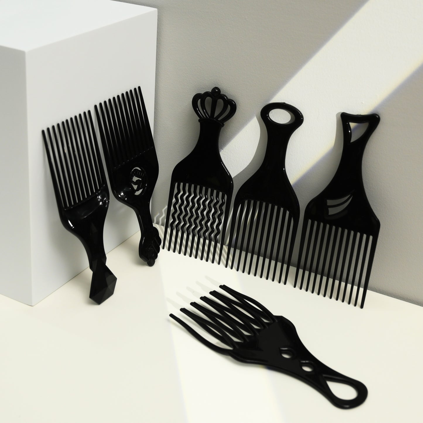 Set of black hair styling combs on a white background