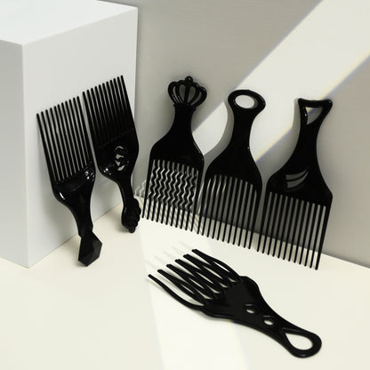 Set of black hair styling combs on a white background